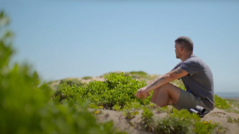 A man looks over a natural landscape