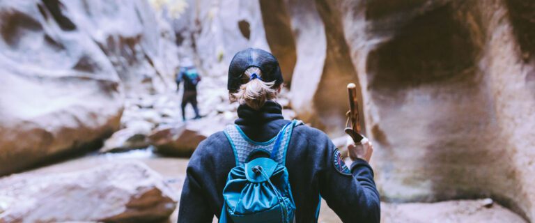 Two hikers are shown from behind